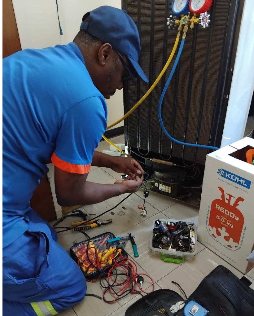 Emergency KIC fridge repair technician fixing a KIC refrigerator at a home in Cape Town with same-day repair service.