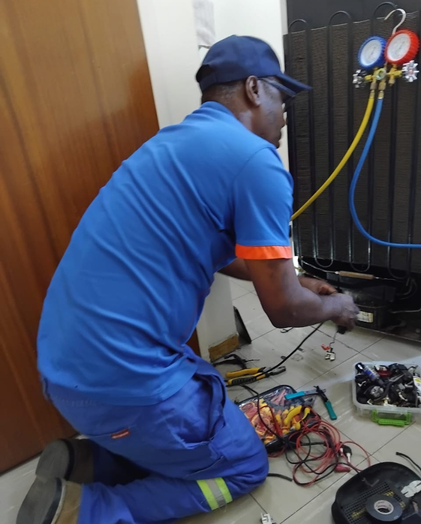 Professional fridge repair technician fixing a refrigerator in Cape Town for residential and commercial customers