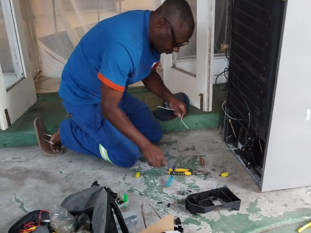 Technician repairing a refrigerator in Cape Town for Total Fix Cape Town