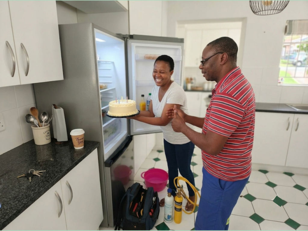 Happy client satisfied after professional fridge repair service.